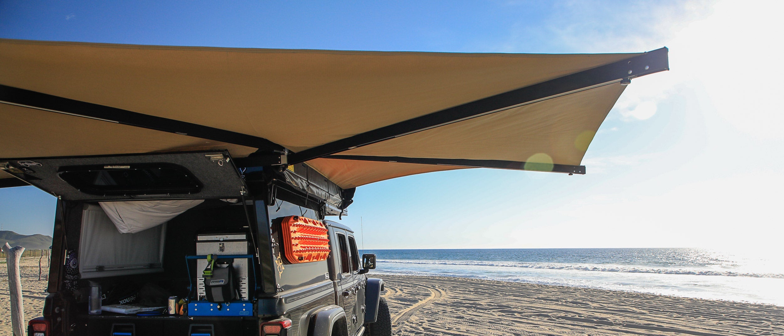 270° vehicle-mounted awning providing expansive shade for overlanding and camping.