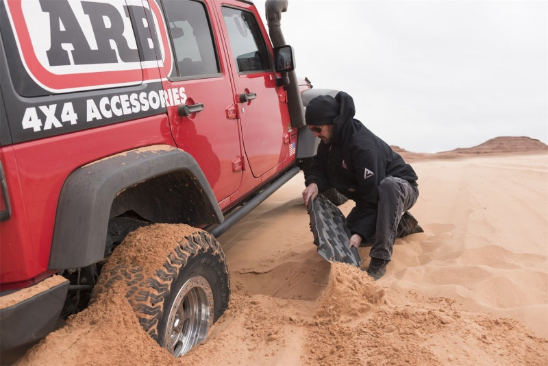 ARB TRED Pro board under a vehicle tire in sand