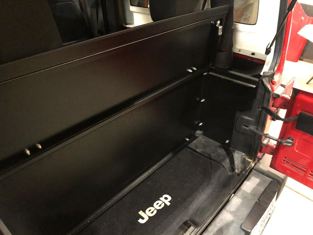Inside the Locker compartment behind a JK rear seat with the Jeep floor mat