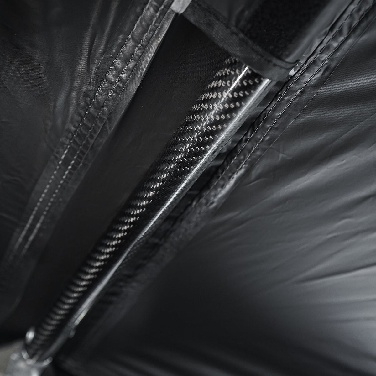 Carbon fiber pole running along the awning fabric
