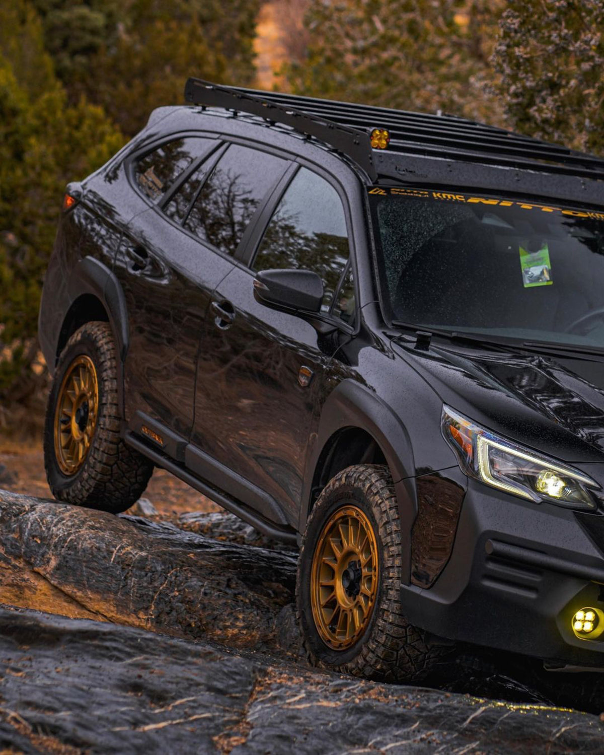 Dark wagon with gold wheels on a rocky trail