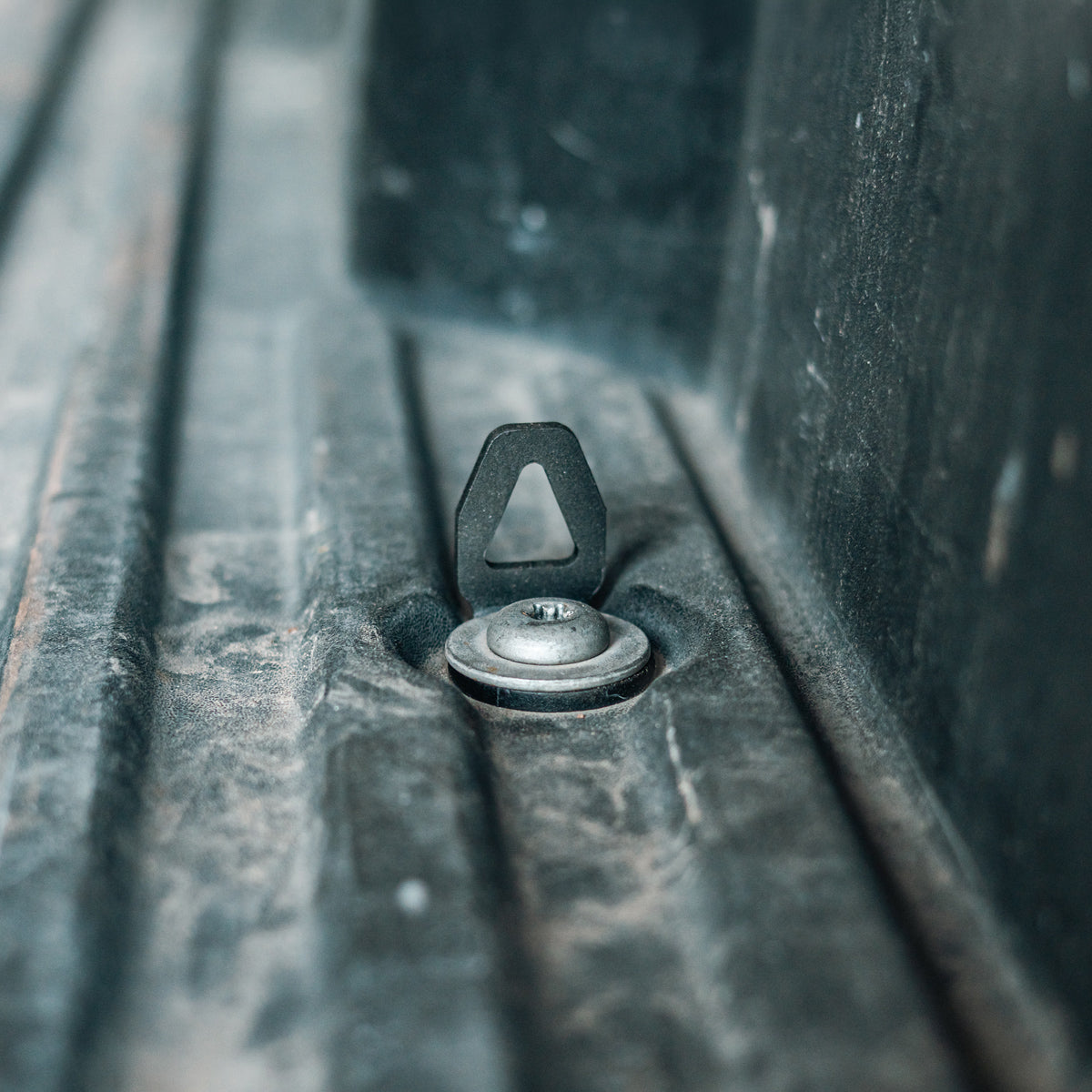 Cali Raised LED bed tie down installed in a truck bed anchor point, wide angled shot