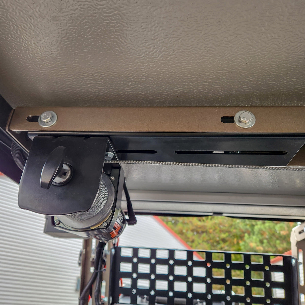 Winch mount above a MOLLE panel, viewed from the bed