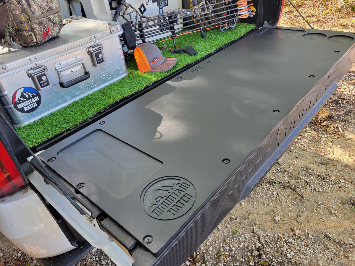 Mountain Hatch panel on a 2022+ Tundra tailgate from the passenger side, recessed tray and logo visible