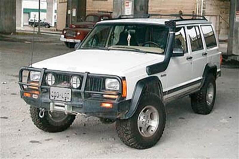 ARB Deluxe winch bumper on a 1984–1996 Jeep Cherokee XJ, front three-quarter view