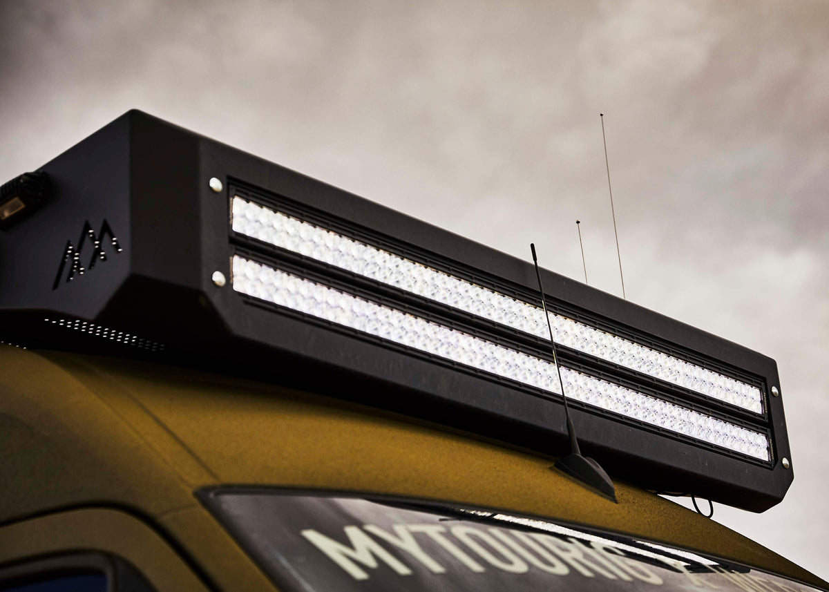50-inch Pathfinder LED light bar installed on a truck's roof rack, low angle shot at dusk