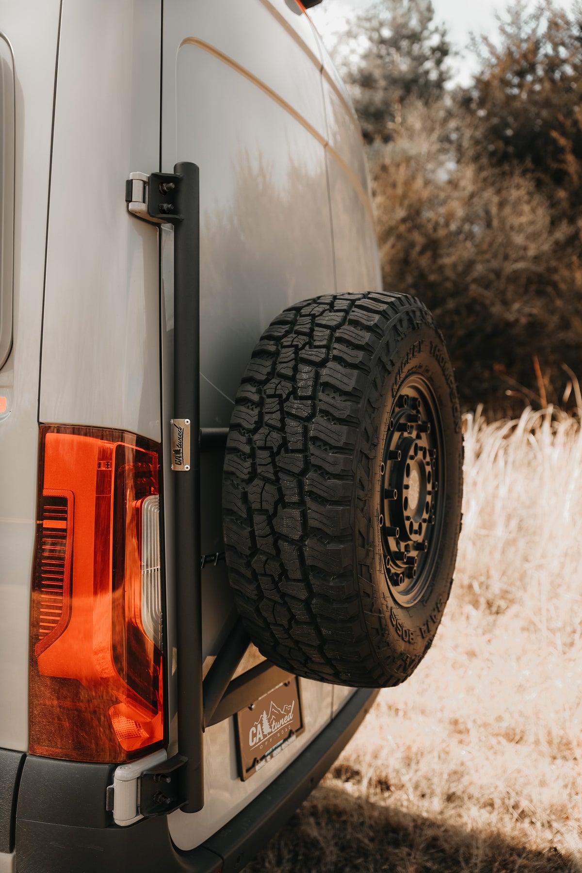 Spare tire on the carrier at the rear corner of a van