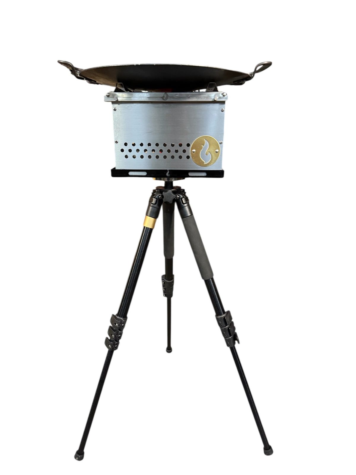 Stainless firebox topped with a round griddle disc, mounted on the tripod stand, studio shot on white background