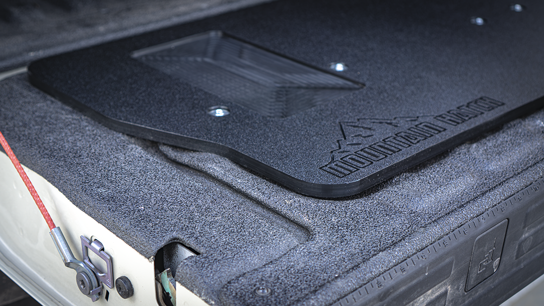 Close-up of the recessed utility tray and Mountain Hatch logo on the 2024+ Ranger panel