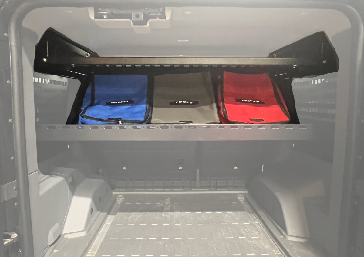 Upper Deck folded down holding blue, gray and red storage bags