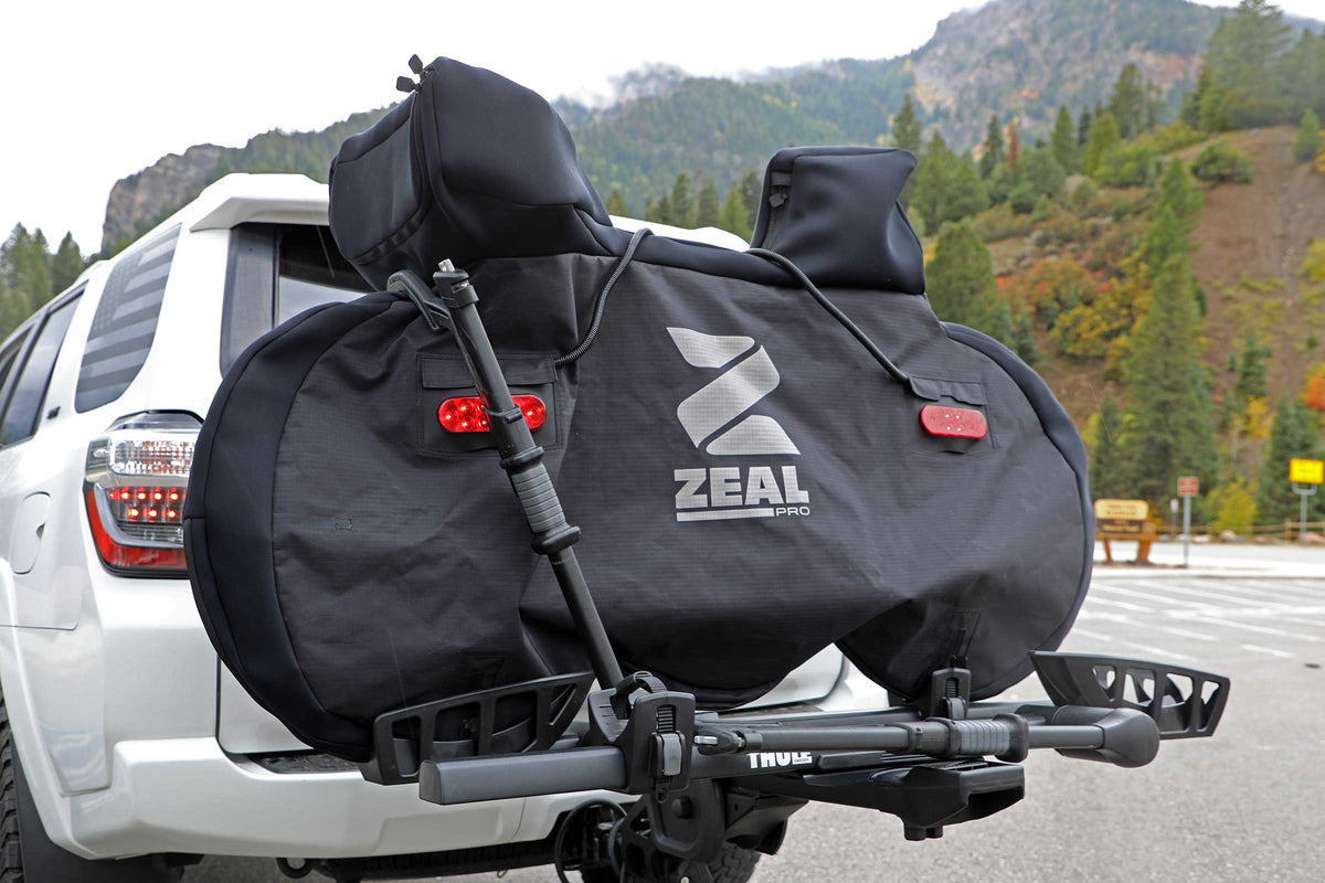 ZEAL Pro road bike cover with tail lights on a tray hitch rack on a white Toyota 4Runner