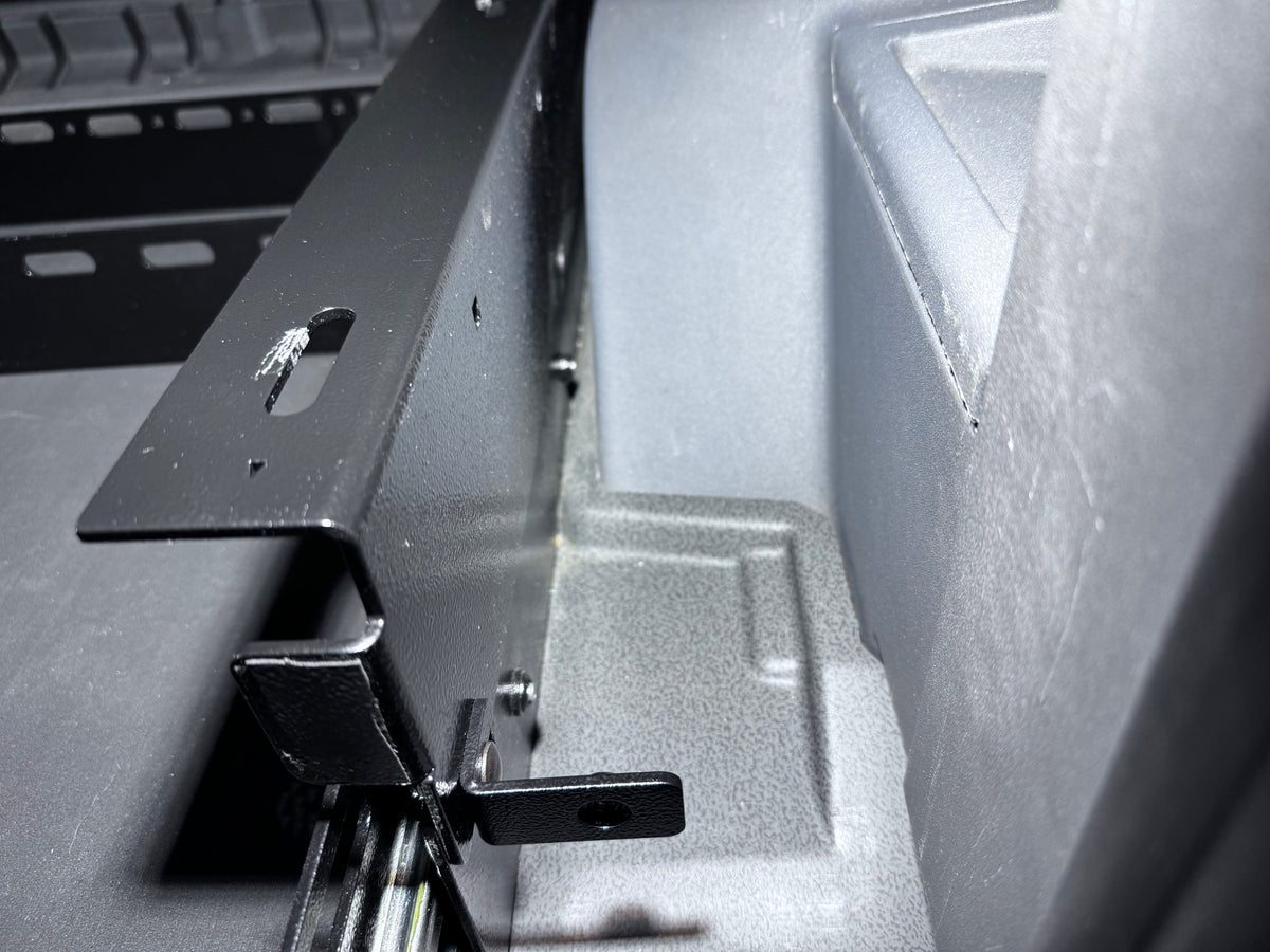 Leveling side panel bracket being fitted alongside the drawer