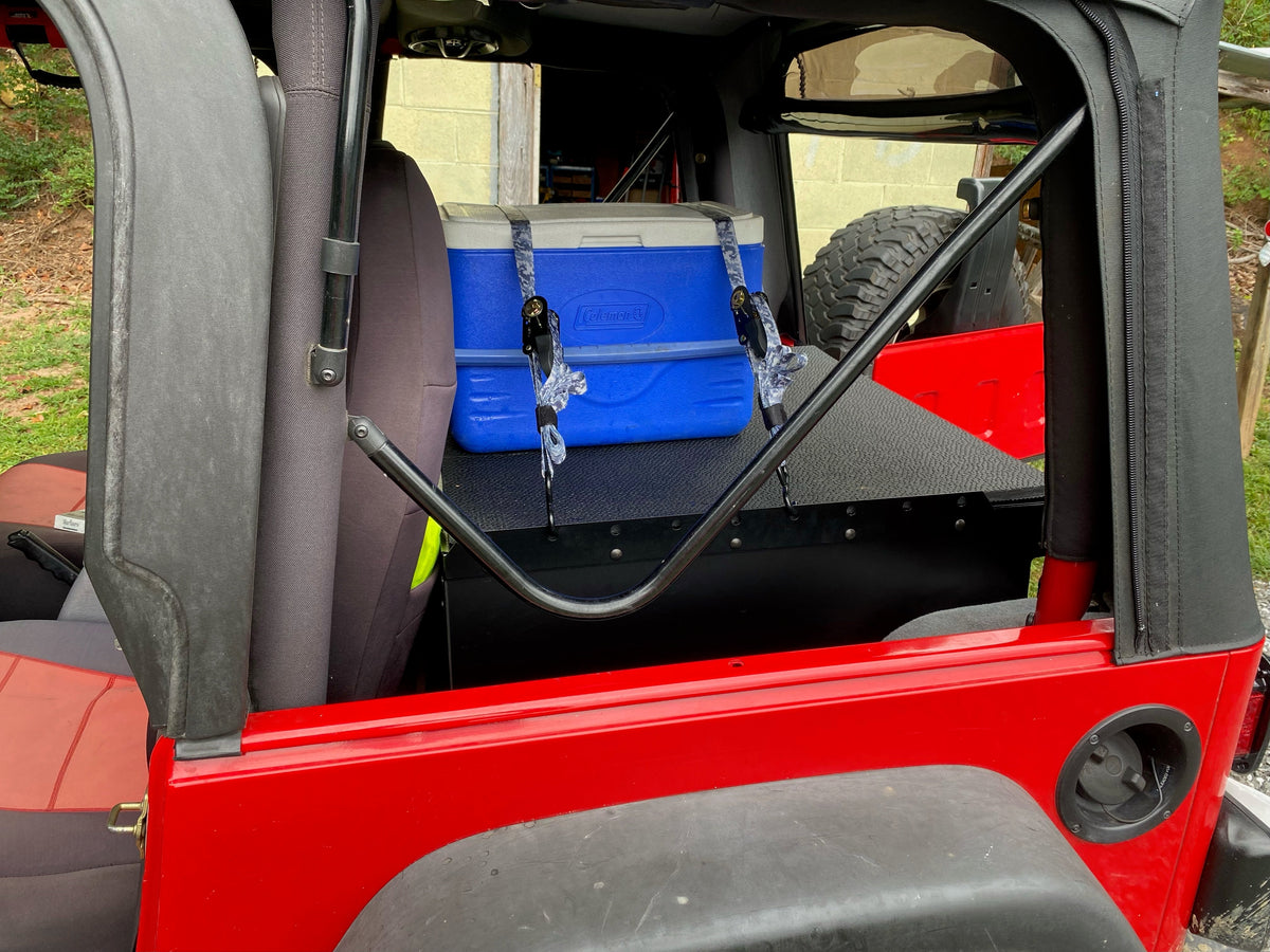 Red TJ with a blue cooler strapped to the Ridgeback tie-down rails