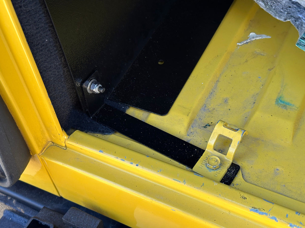 Ridgeback mounting bracket bolted at a factory tie-down point in an LJ