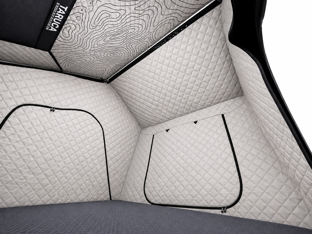 Interior of the Dark Rogue tent looking toward a corner with quilted walls and zippered openings