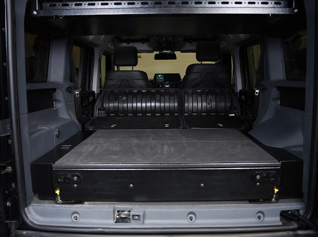 Grenadier drawer system with leveling panels filling the cargo area, rear view