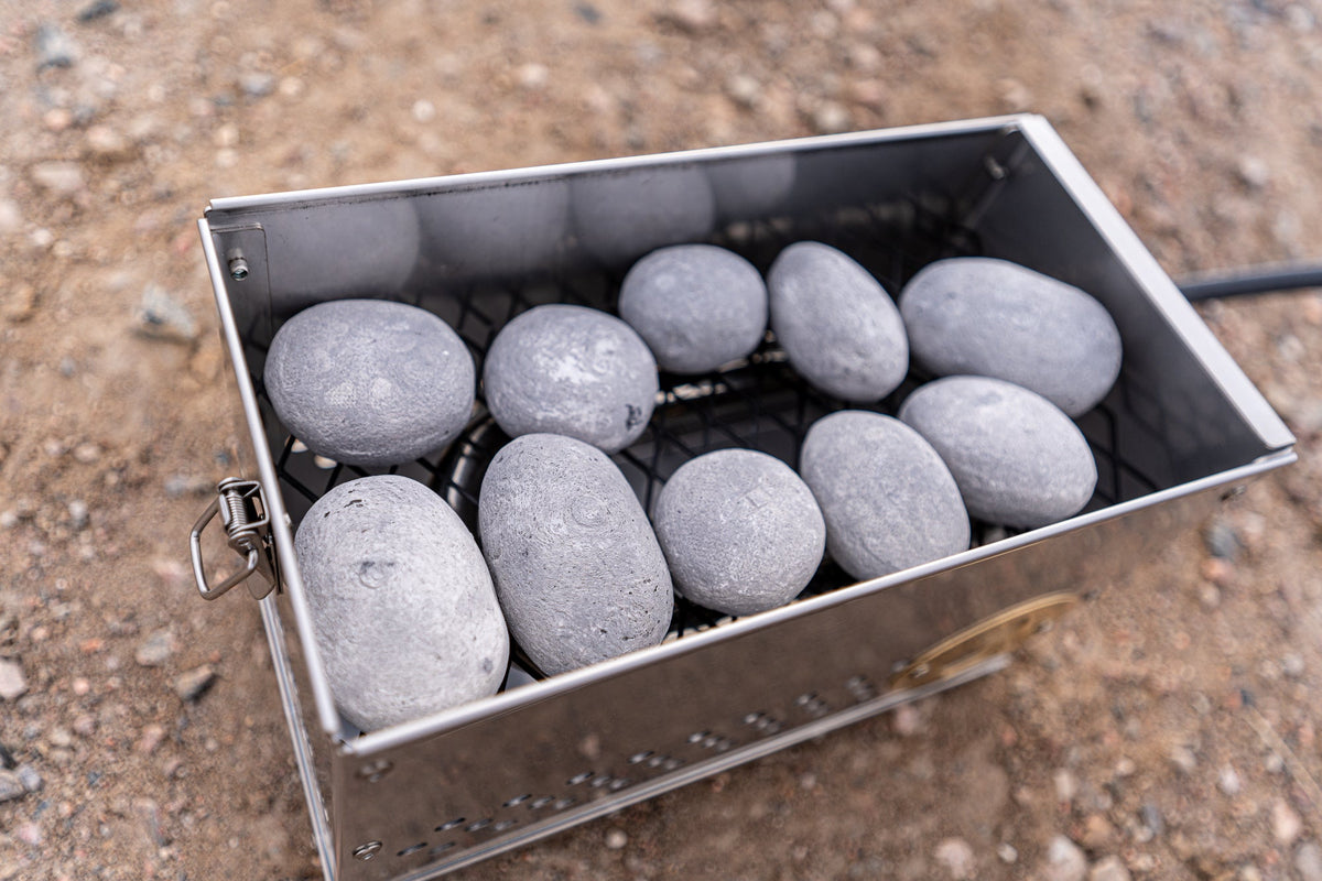 Close-up overhead shot of the stainless firebox filled with light gray Hades Stones