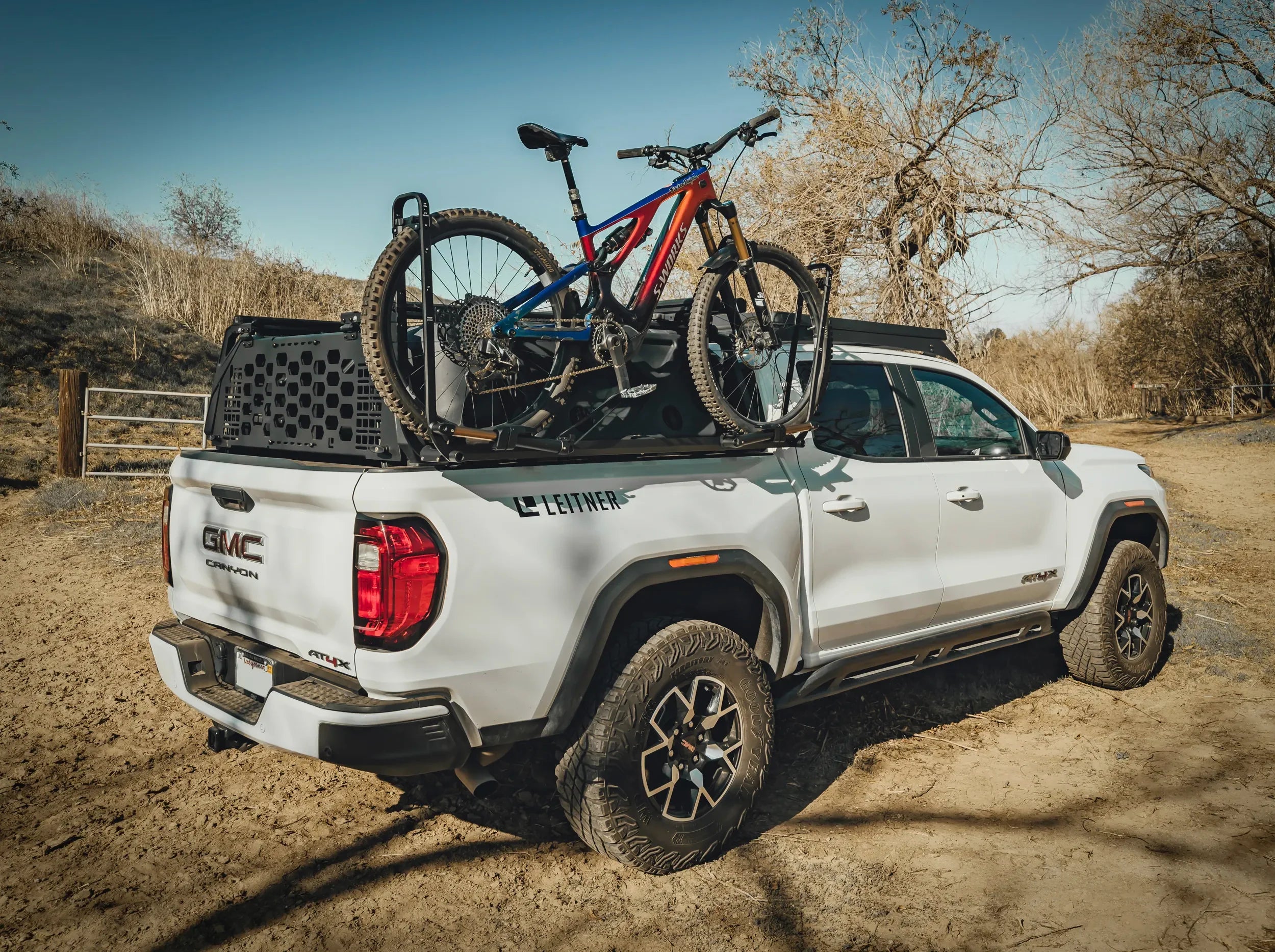 WHITE GMC TRUCK OUTSIDE WITH BIKE ON BLACK KUAT PISTON SR BIKE RACK MOUNTED TO FORGED BIKE MOUNT