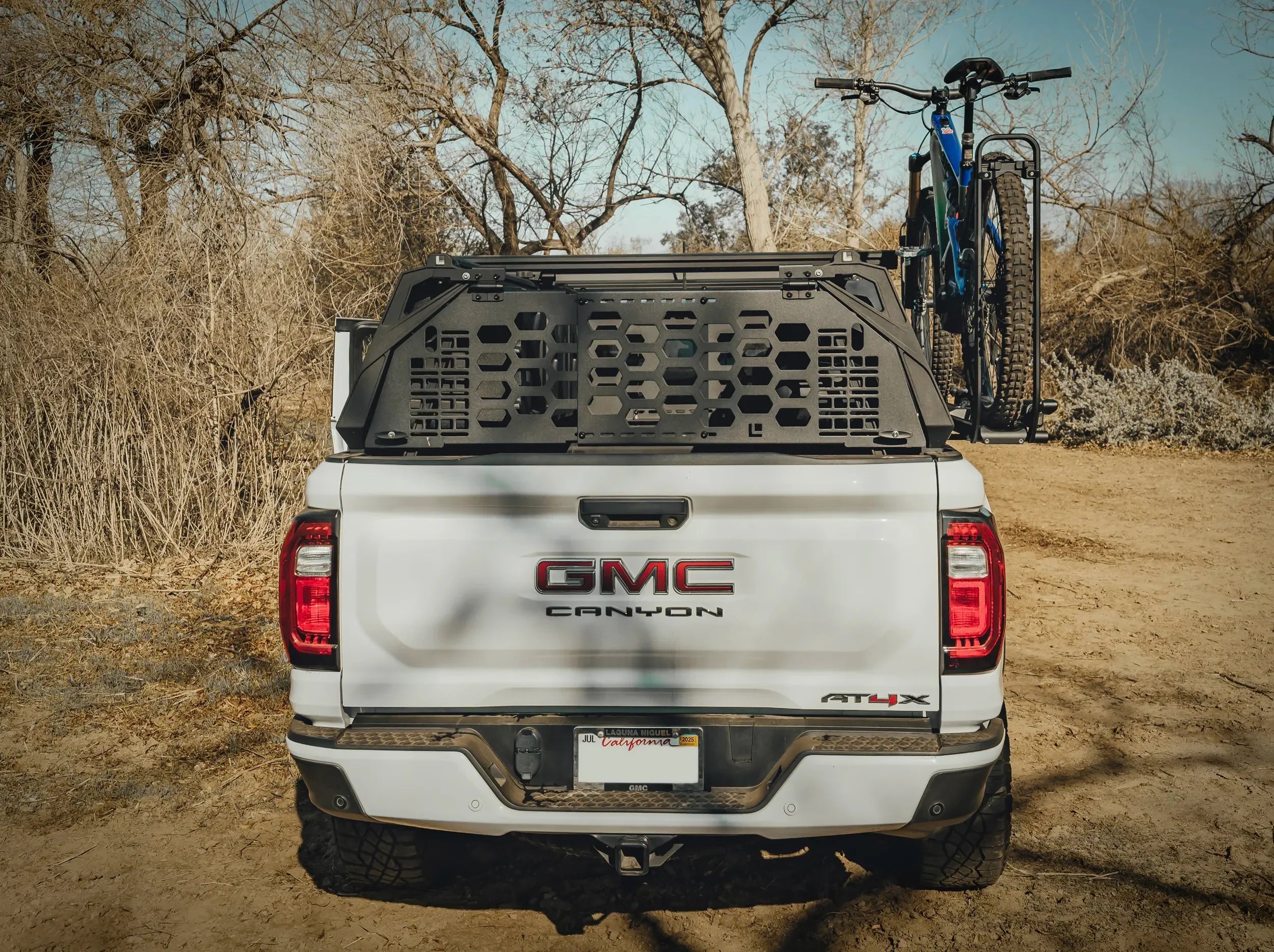 REAR VIEW OF BIKE MOUNTED ON WHITE GMC TRUCK