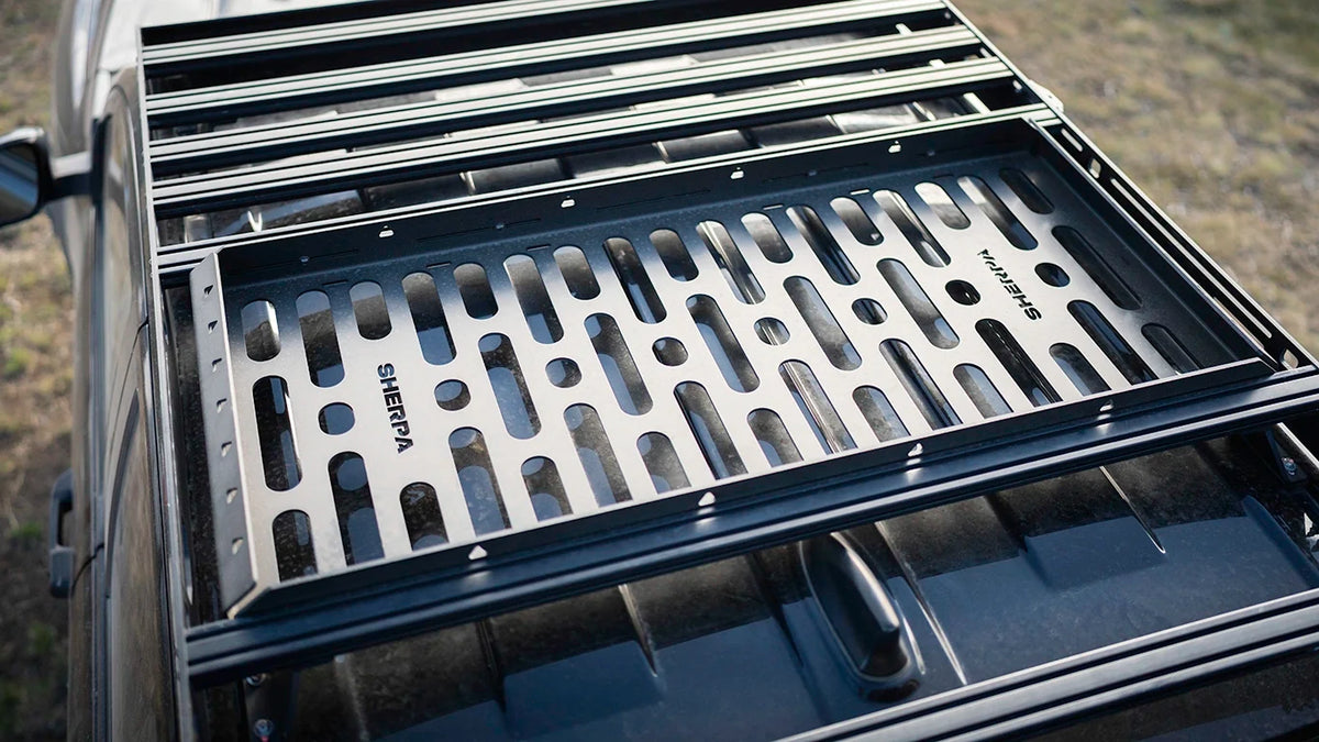 Wide shot of the empty Roof Rack Storage Basket mounted across a vehicle's roof rack crossbars