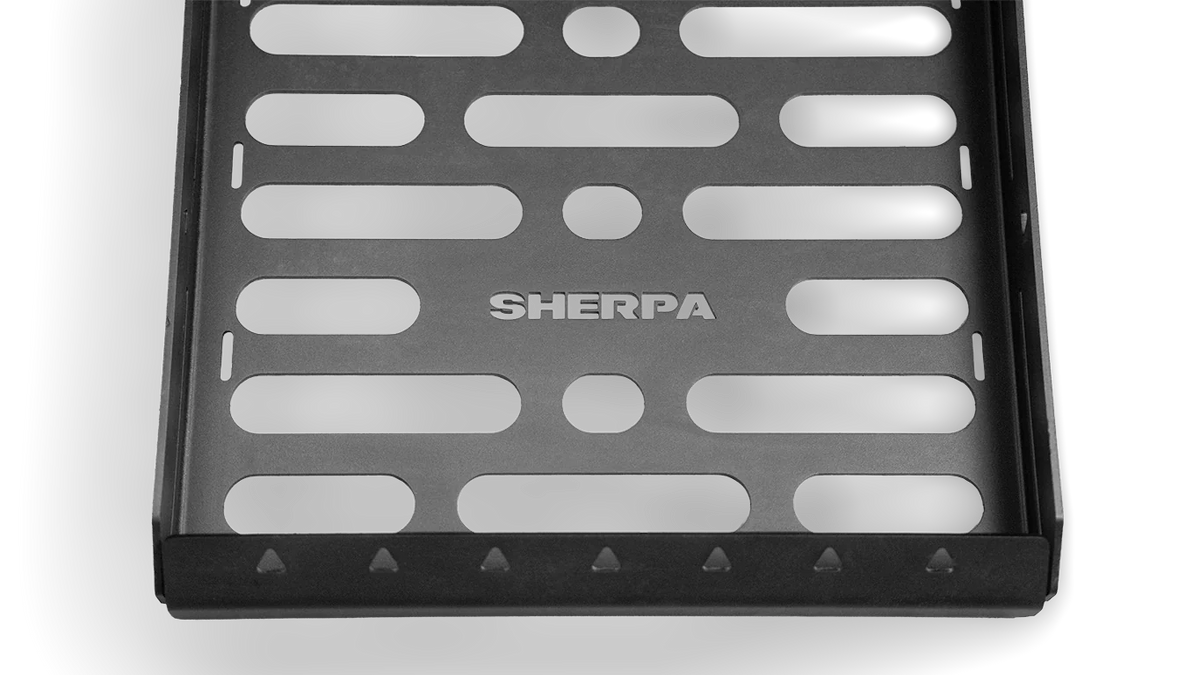 Overhead studio shot of the Roof Rack Storage Basket showing the stamped SHERPA logo and triangular tie-down points