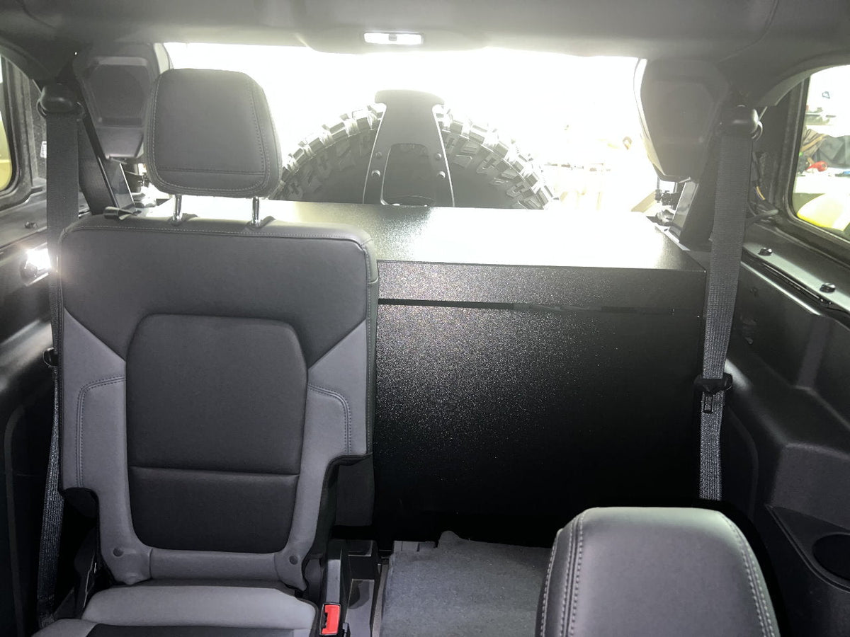 Locker enclosure seen from the Bronco front seat, standing behind the rear seat