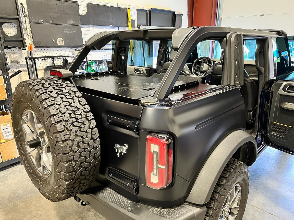 Black Ford Bronco 4-door with the top off and the Slipstream enclosure closed