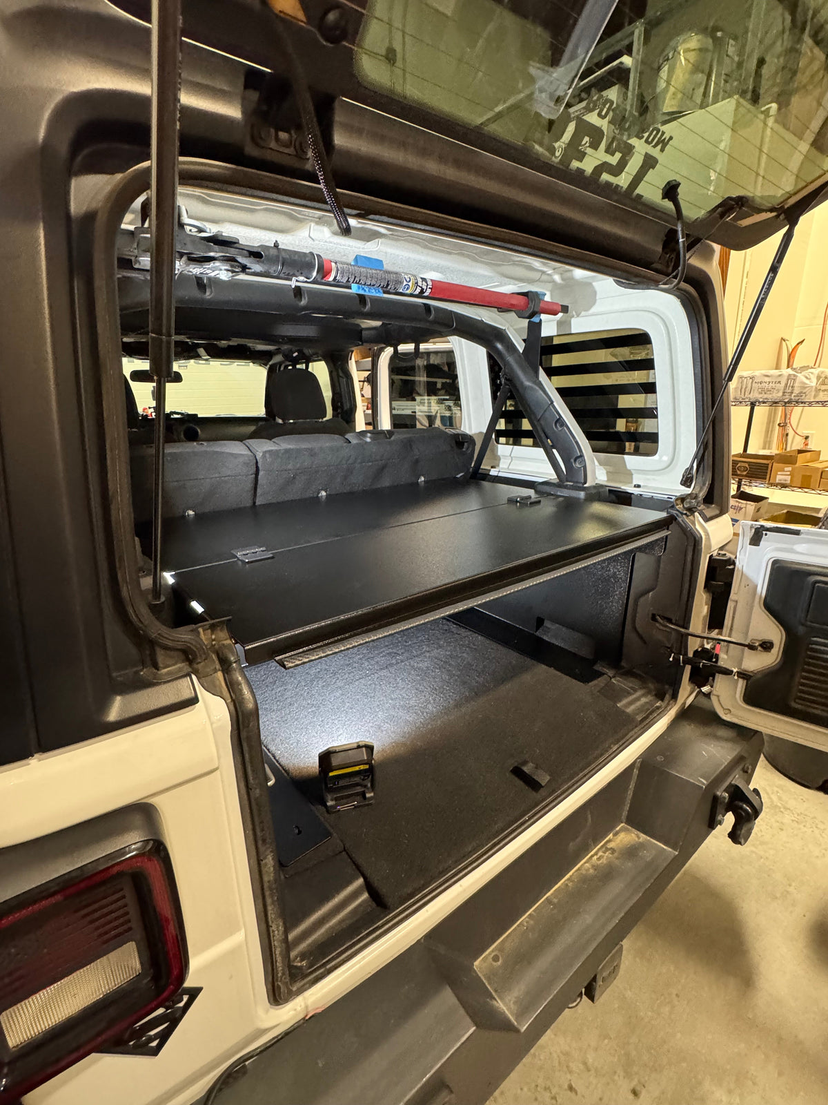 Ridgeback lid lifted in a JLU with the cargo floor lit underneath