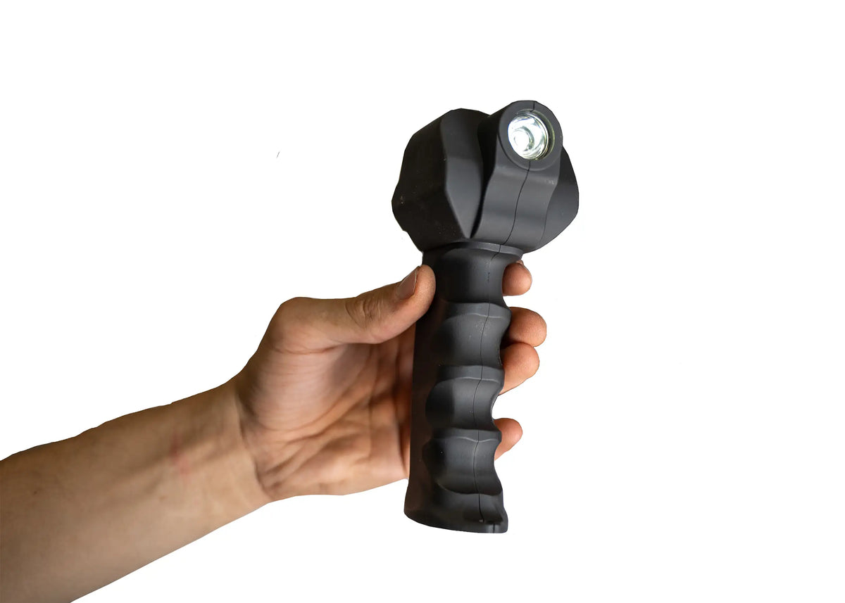 Hand holding the winch's wireless remote control with its built-in flashlight lit