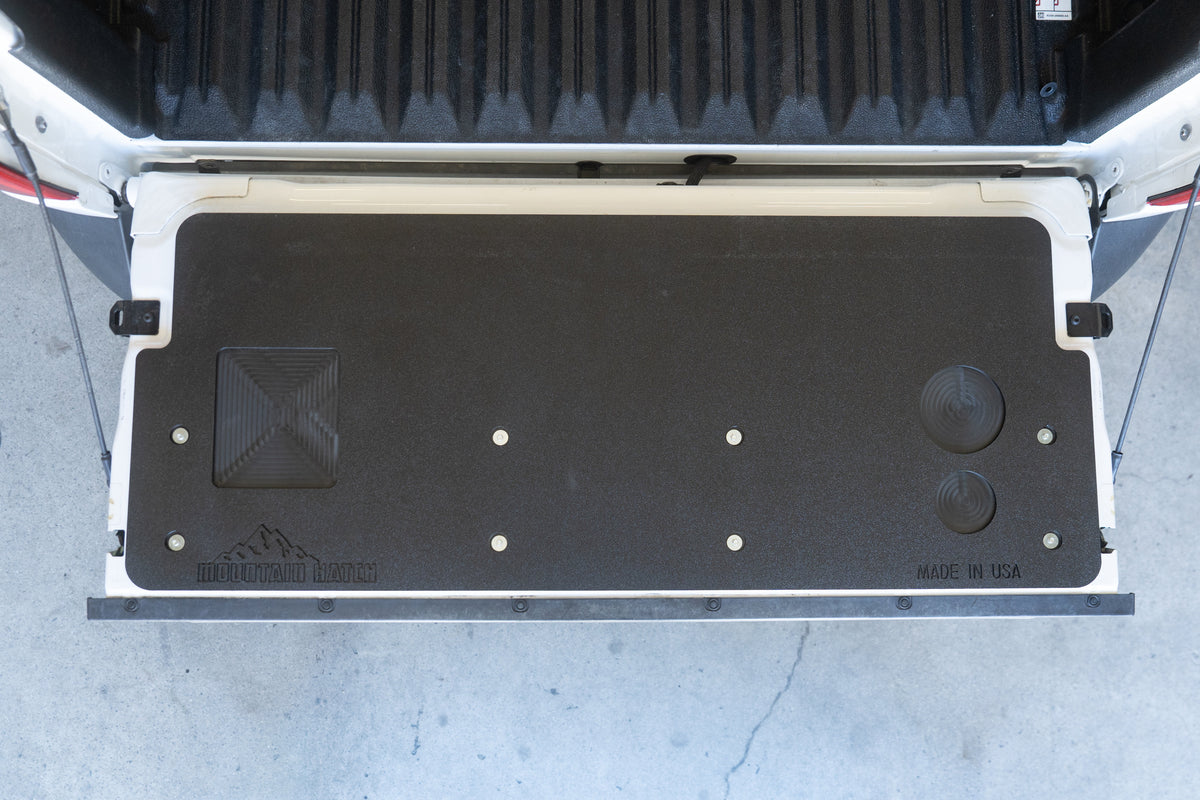 Flat-on view of the Mountain Hatch Maverick panel showing the recessed tray, drink holders and mounting screws