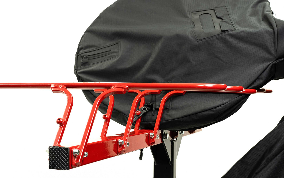 Front wheel section of a modified ZEAL Pro cover sitting in a red VelociRAX hitch rack tray