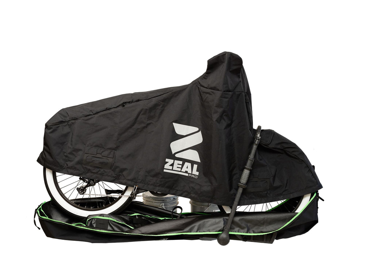 Top section of the e-bike cover being zipped over a step-through e-bike on a tray rack