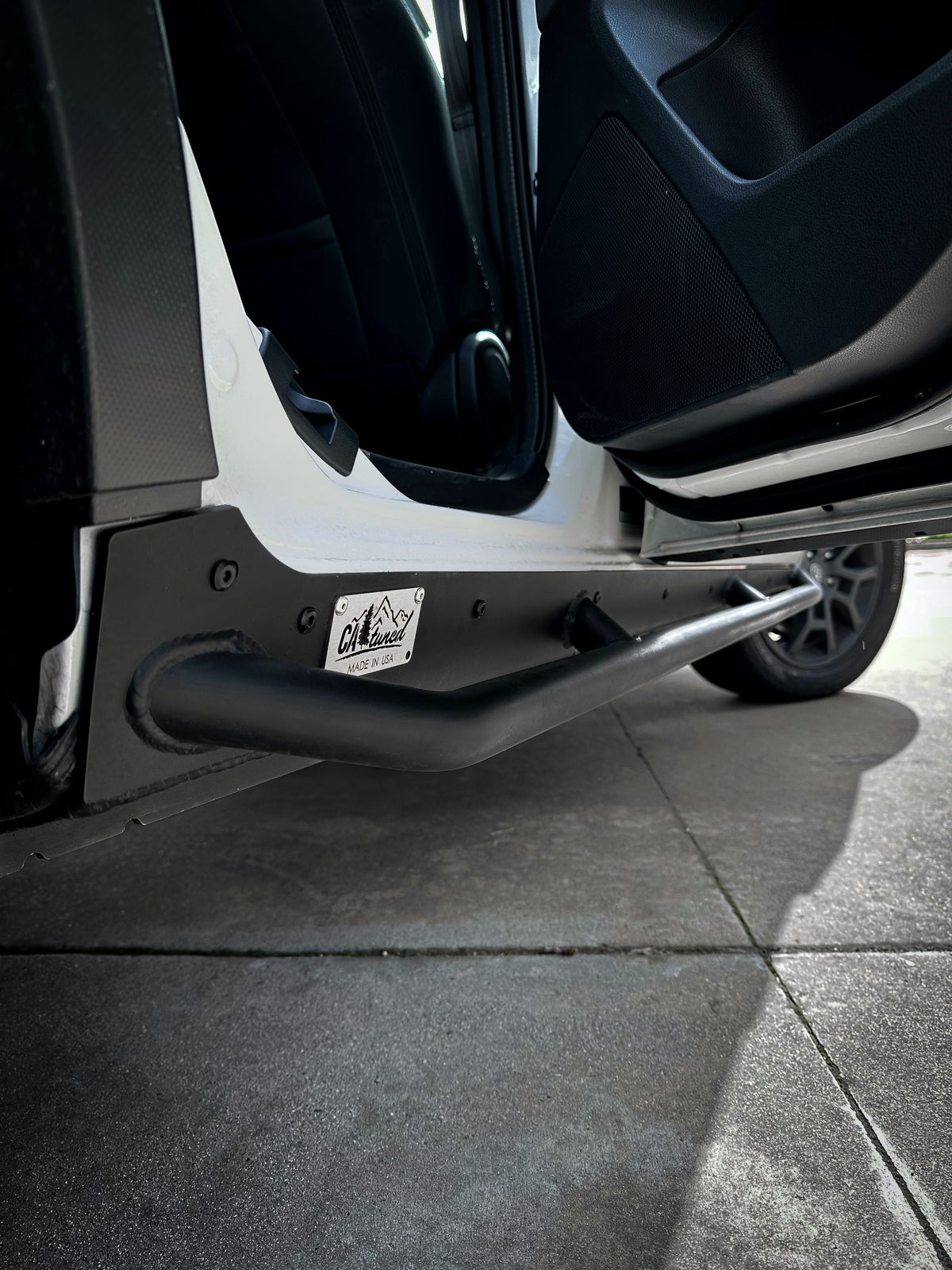 Close view of the front end of a black rock slider beside the door opening