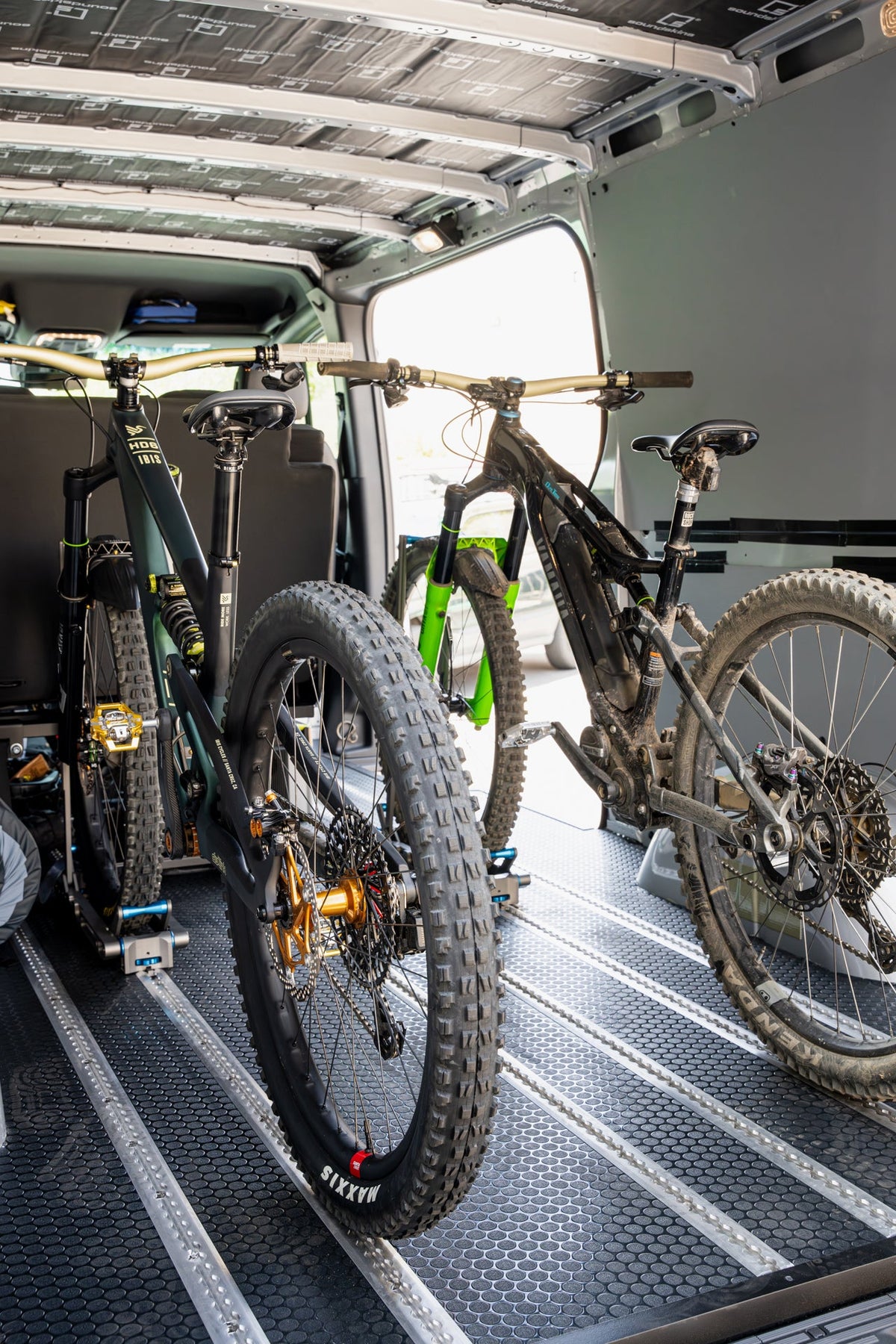 Two bikes on HOVR racks installed on north-south L-track in a van