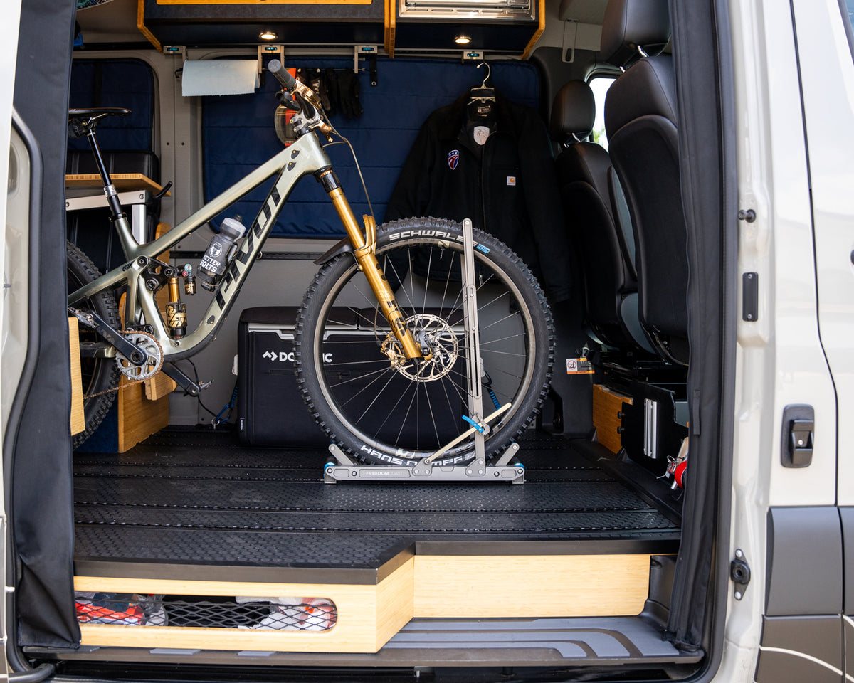Bike loaded into a HOVR rack seen through open van rear doors