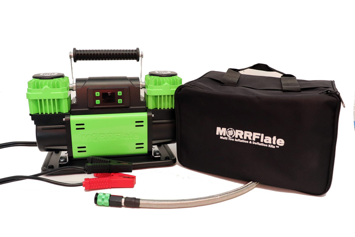 MORRFlate TenSix PSI Pro compressor with digital pressure control panel on top, shown beside its black carrying bag, braided hose, and battery clamps