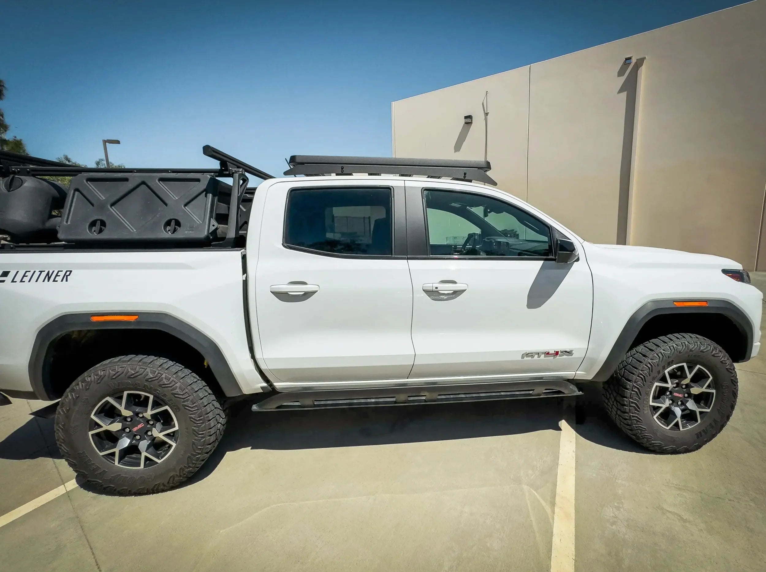 SIDE VIEW OF WHITE GMC CANYON WITH ACS ROOF RACK MOUNTED
