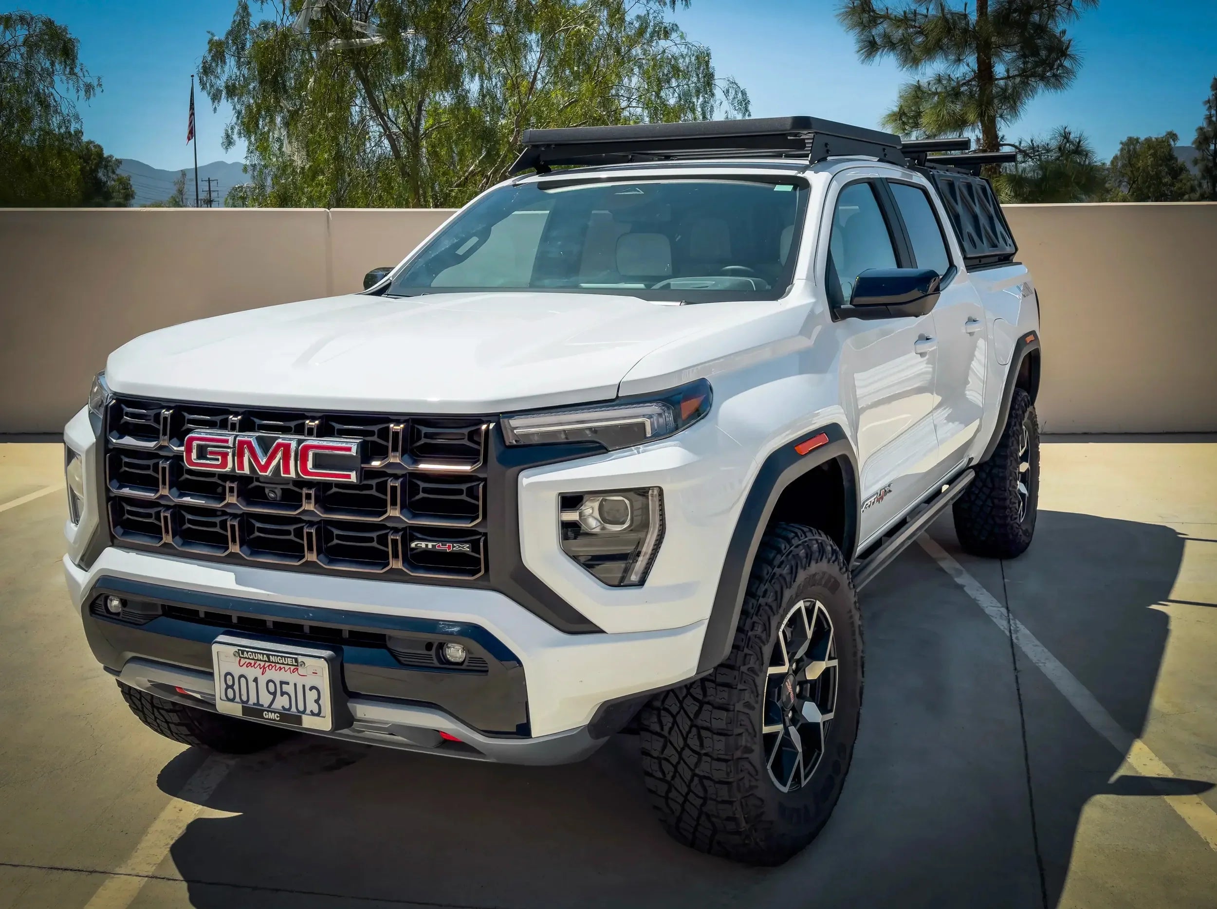 FRONT VIEW OF WHITE GMC CANYON WITH ACS ROOF RACK MOUNTED