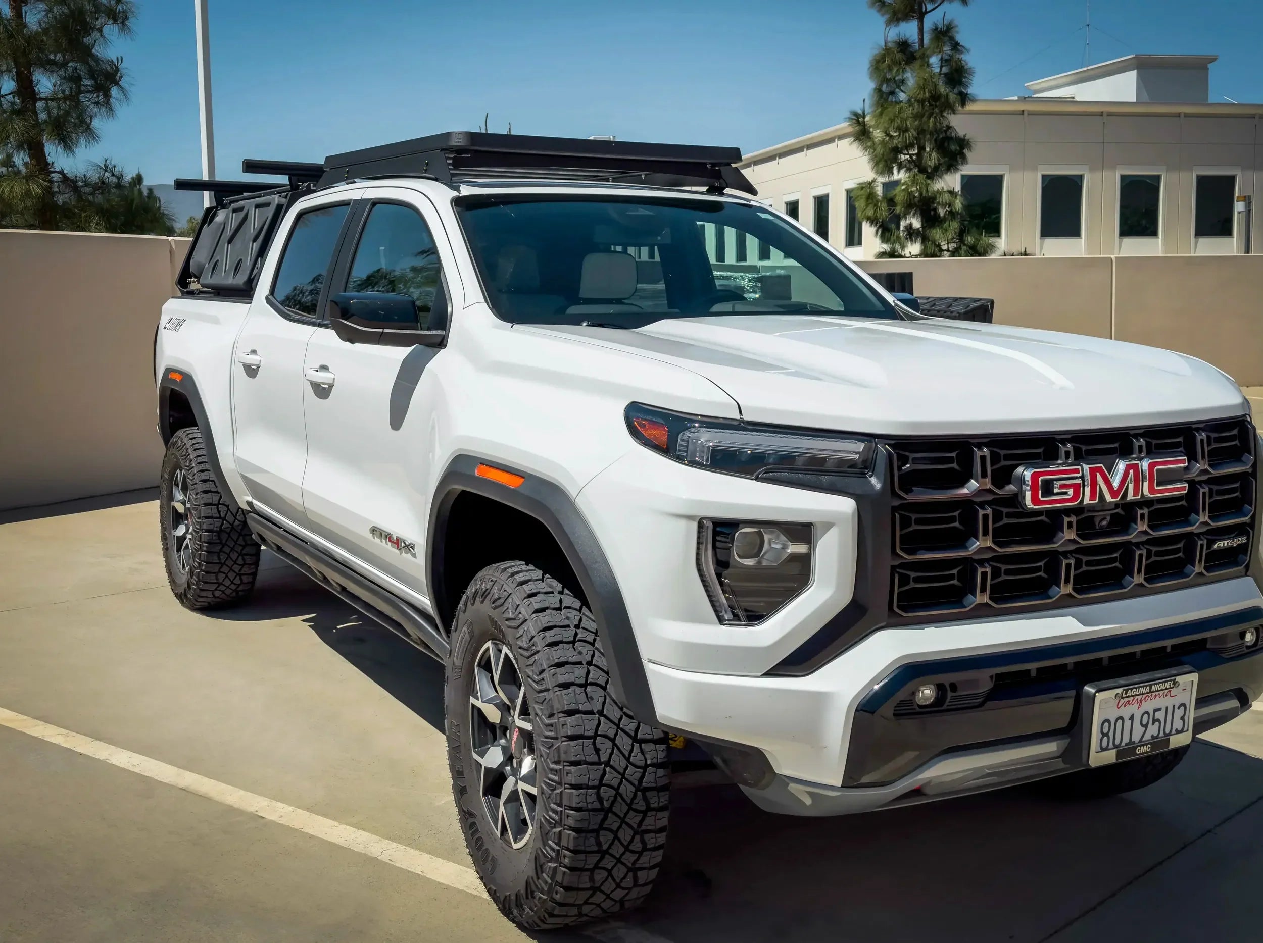SIDE VIEW OF WHITE GMC CANYON TRUCK WITH ACS ROOF MOUNTED