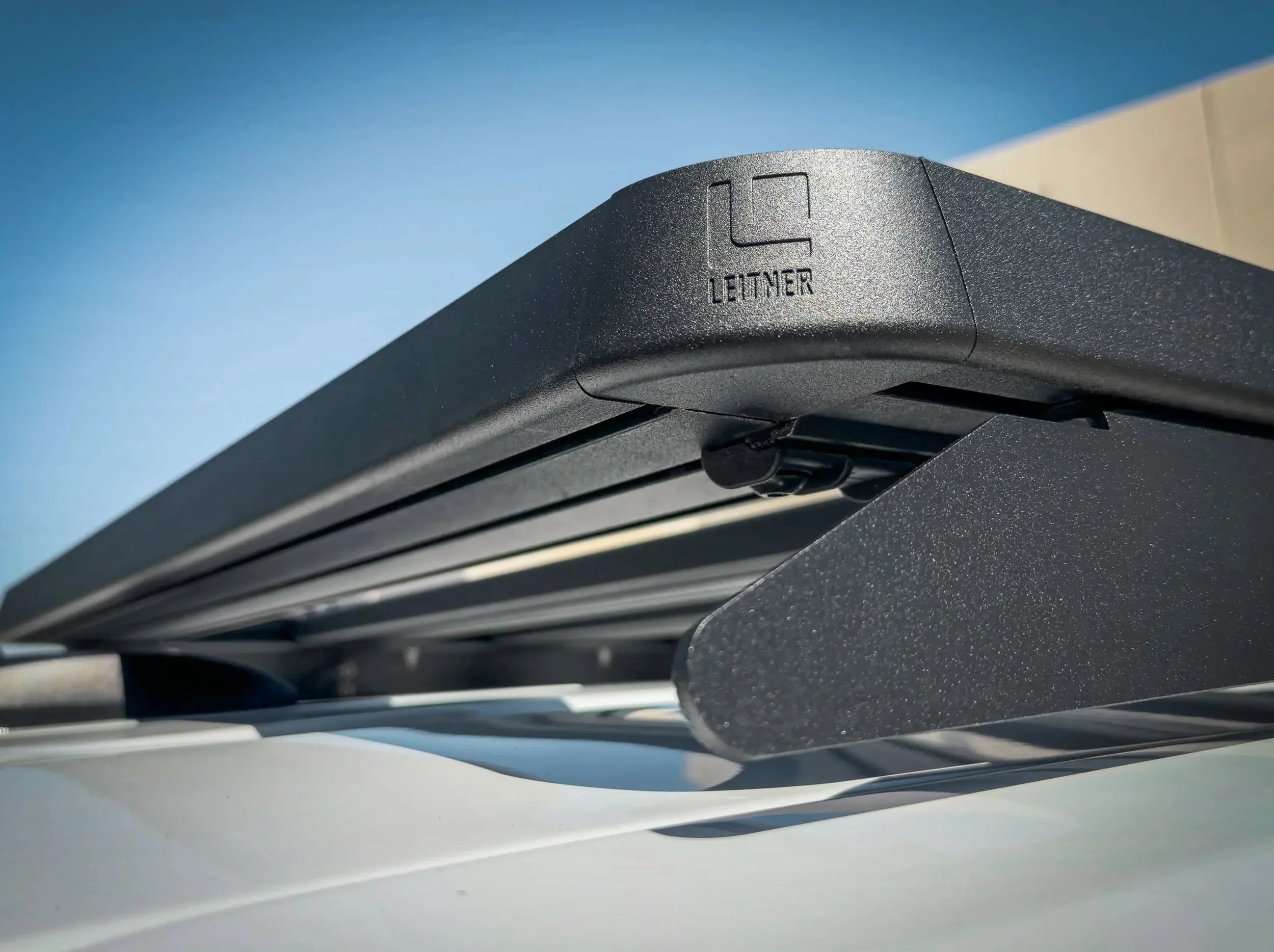 CLOSE UP VIEW OF CORNER CAP WITH LEITNER LOGO ON ACS ROOF RACK