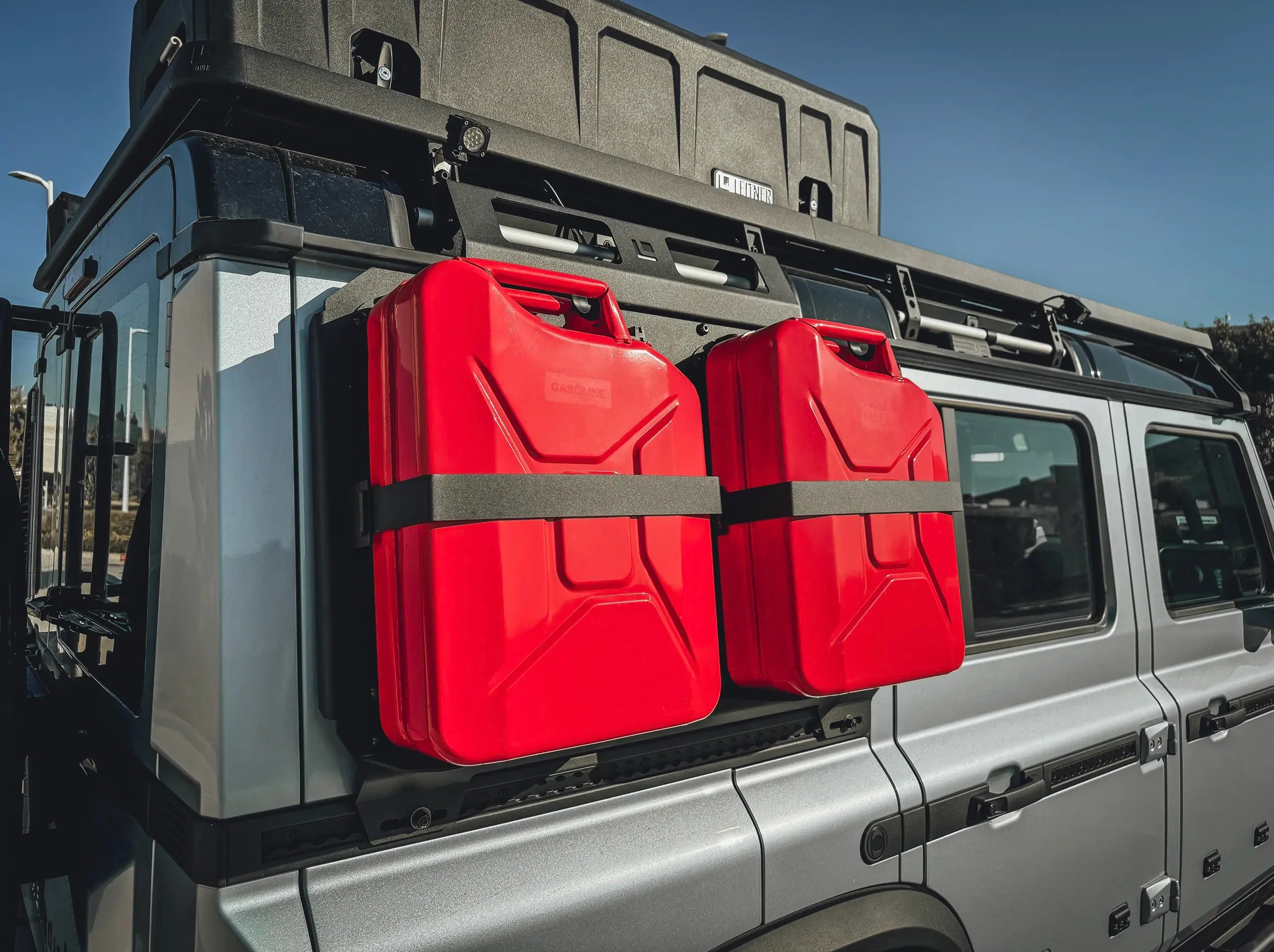 FRONT VIEW OF 2 RED JERRYCANS HELD BY TWO JERRYCAN HOLDERS