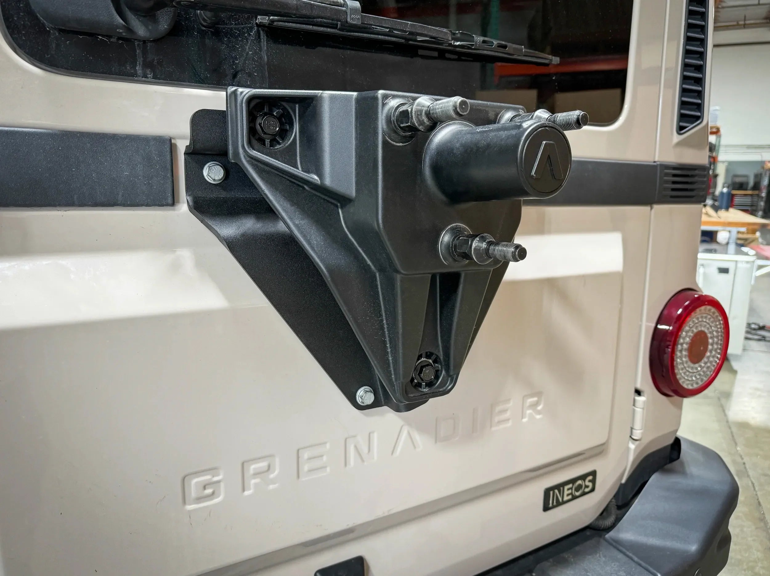 CLOSE UP VIEW OF GRENADIER TIRE RELOCATION BRACKET MOUNTED