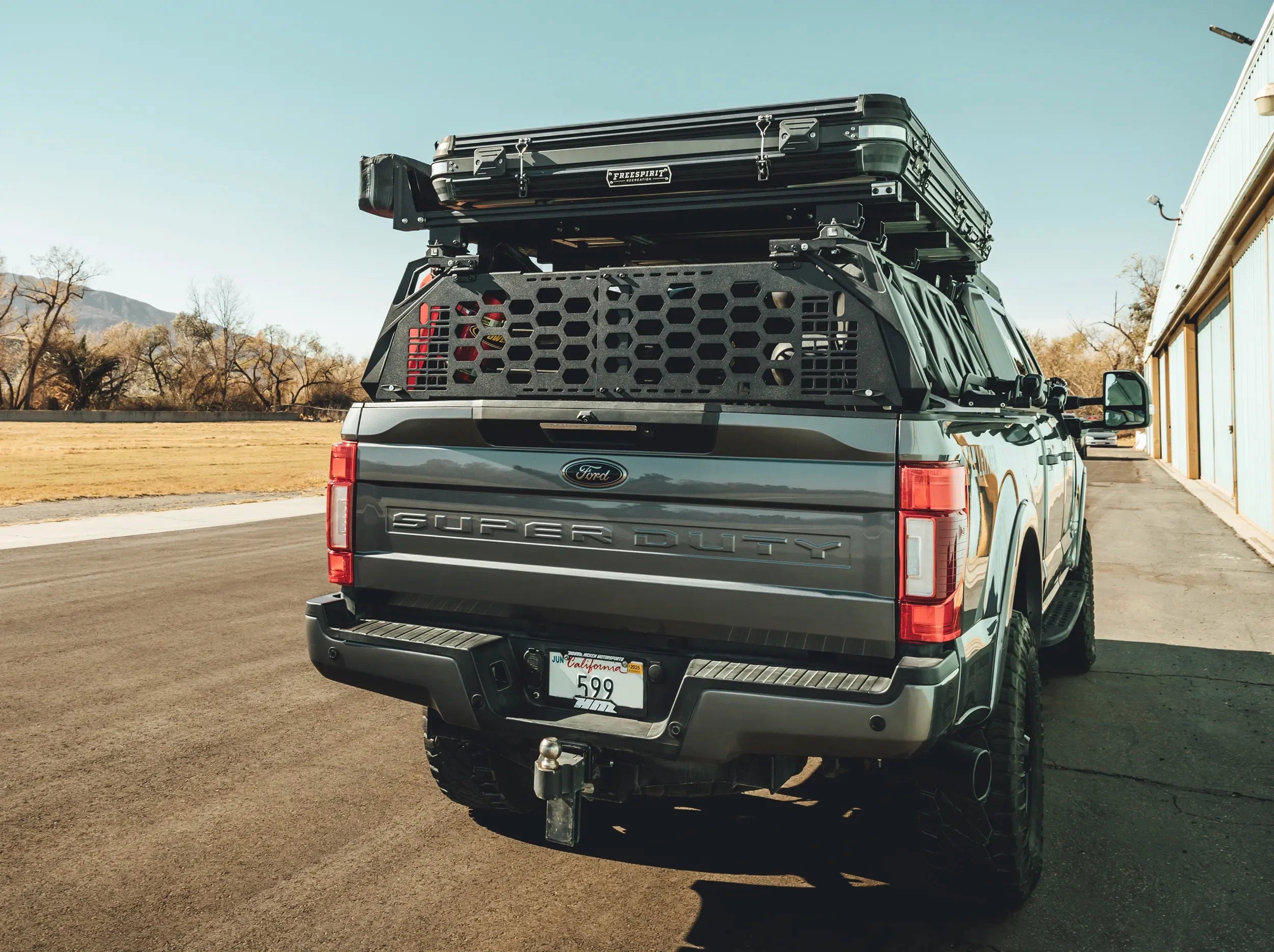 REAR VIEW OF BLACK GATEKEEPER MOUNTED ON REAR OF TRUCK BED