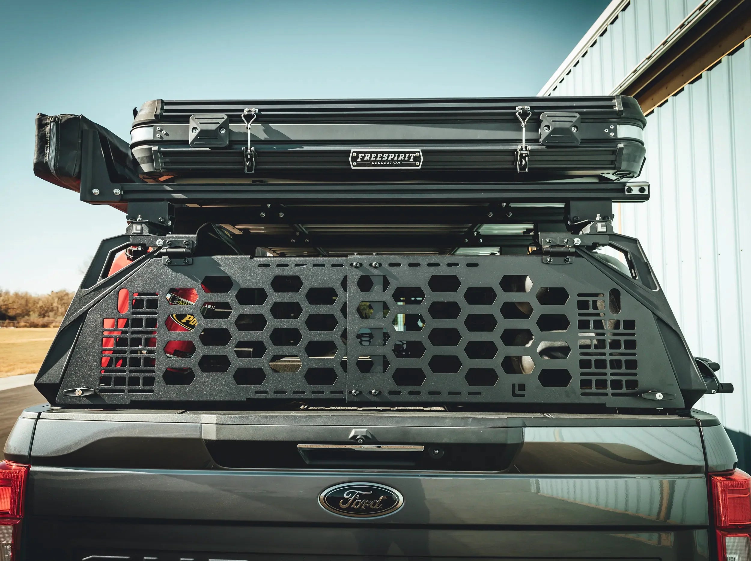 REAR VIEW OF TRUCK WITH BLACK GATE MOUNTED ON REAR OF ACS FORGED BED RACK