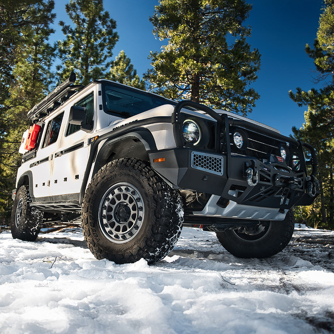 Silver SUV with a black bull bar on a snowy trail