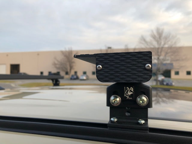 Close-up of K9 load bar end cap and mounting foot on a roof