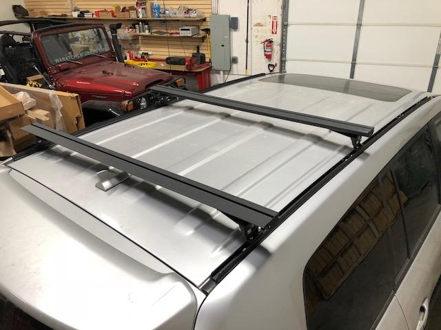 Eezi-Awn K9 load bars on a silver SUV roof