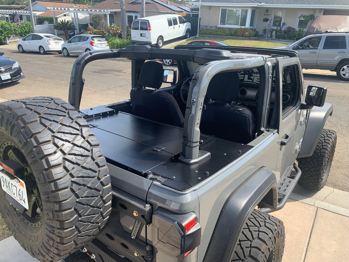 Gray Jeep JK 2-door from the rear quarter with the top off and the Slipstream closed