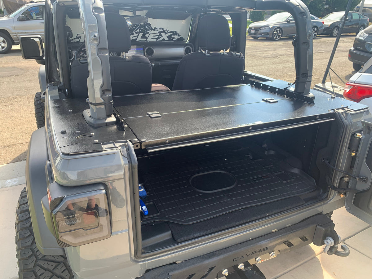 Gray Jeep with the tailgate open and the Slipstream folding top closed over the cargo area