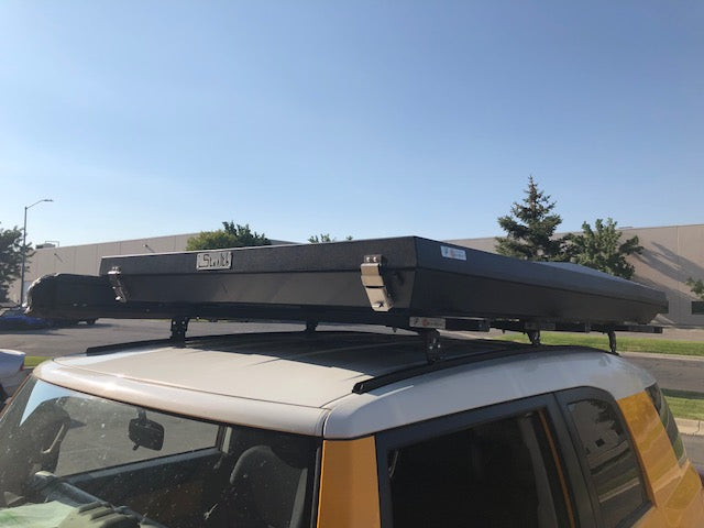 Roof top tent mounted on K9 load bars on a Toyota FJ Cruiser
